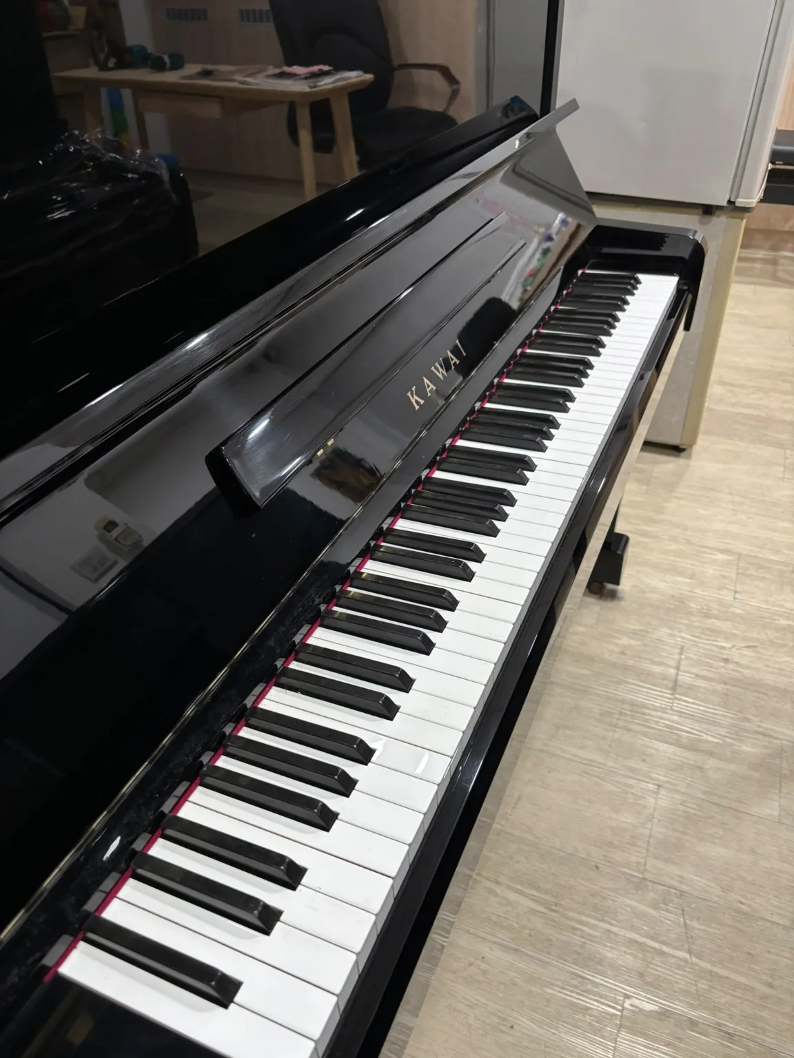 Kawai NS-10N polished ebony upright piano keyboard and cabinet
