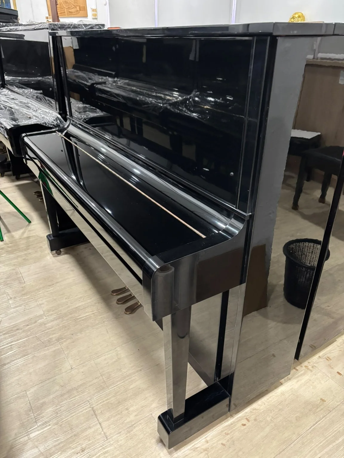 Full polished ebony cabinet view of Kawai NS-10N upright piano