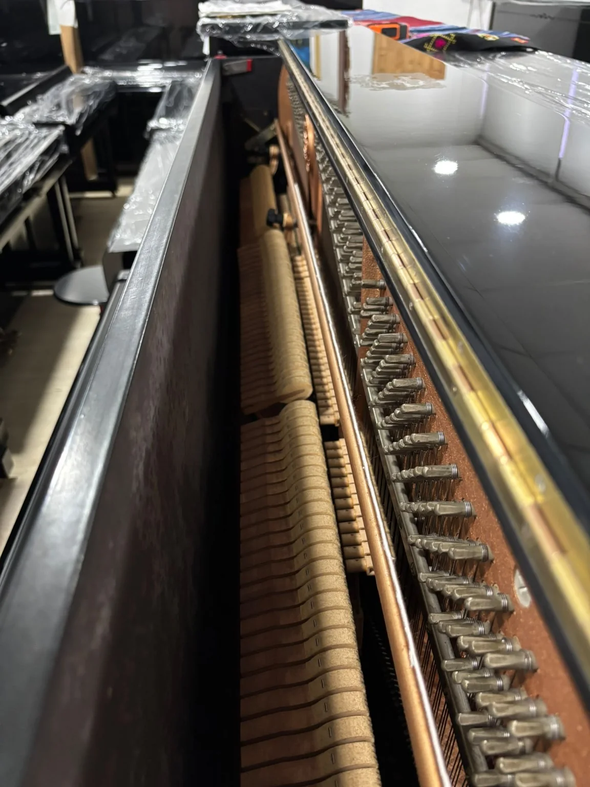 Interior view of Kawai NS-10N upright piano action and tuning pins