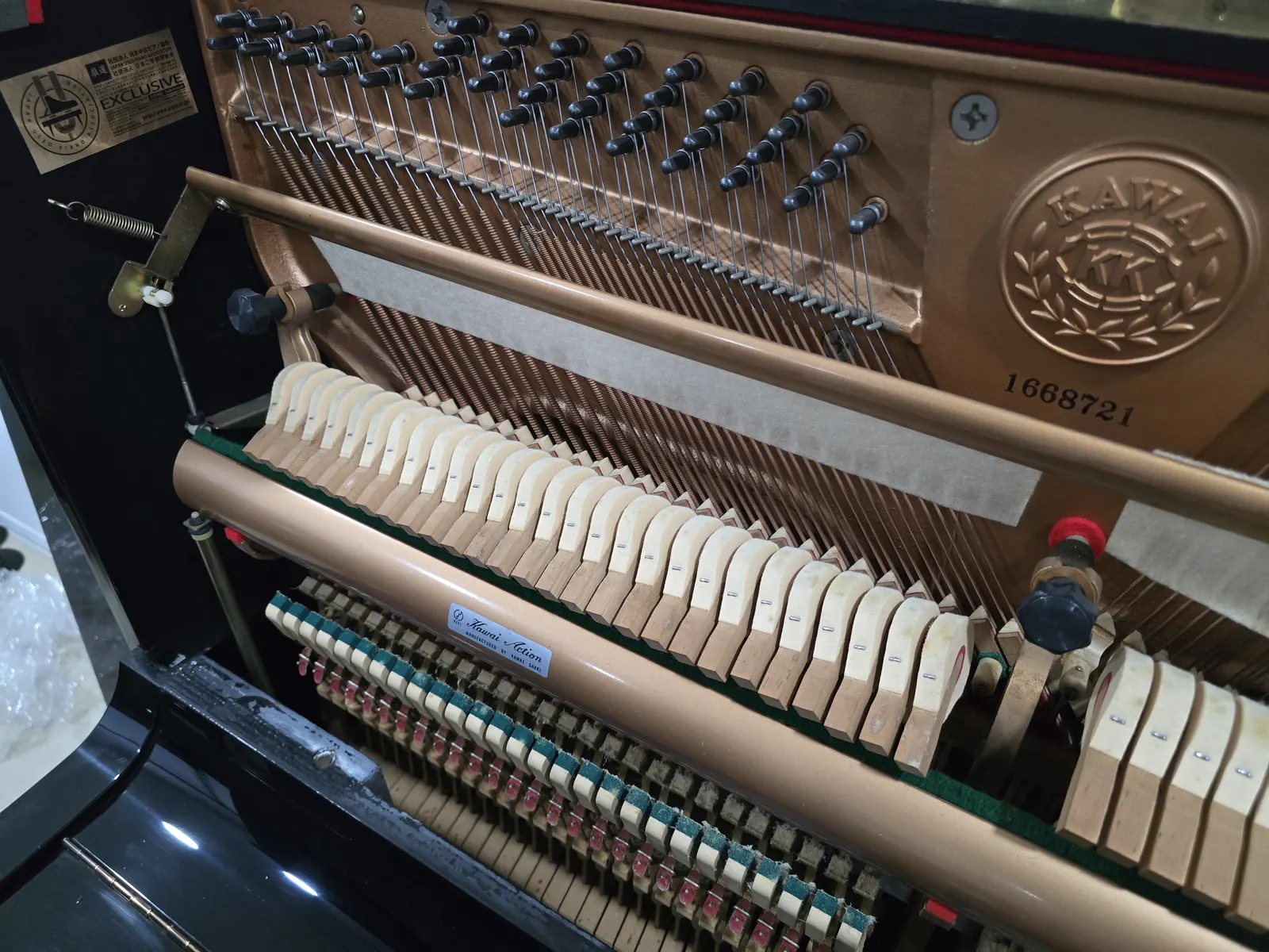 Interior action and frame of Kawai NS15 upright piano
