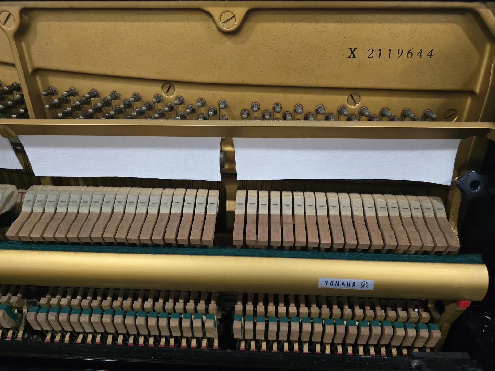 Interior action and frame of Yamaha UX upright piano