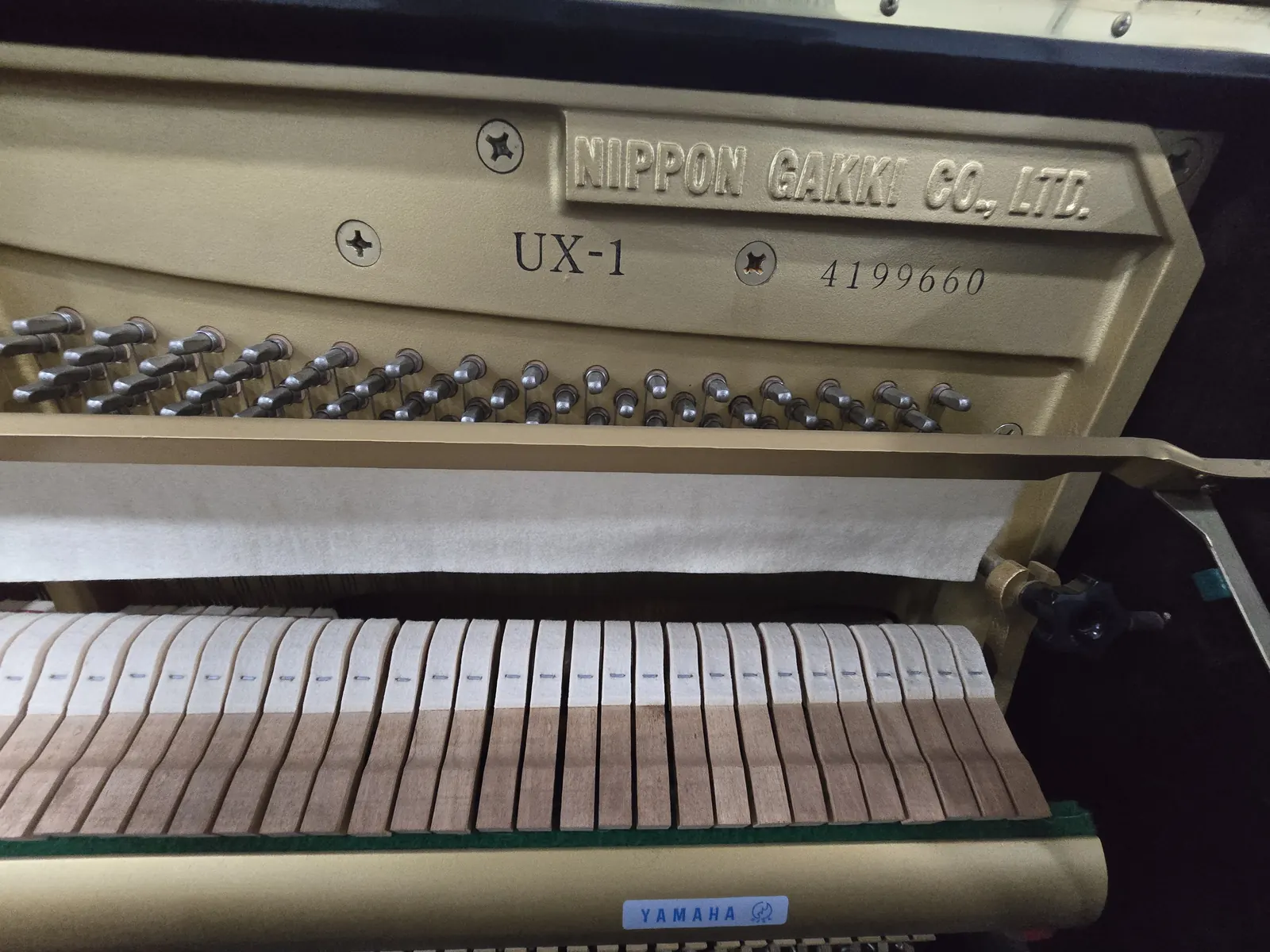 Interior action and frame of Yamaha UX1 upright piano