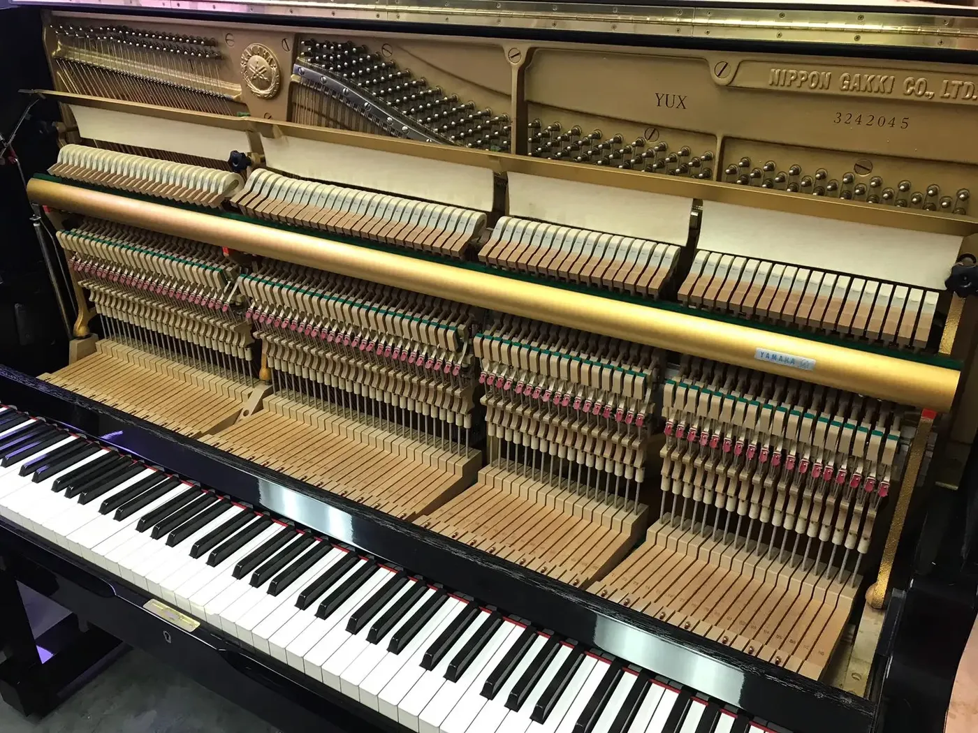 Interior or serial detail of Yamaha YUX upright piano